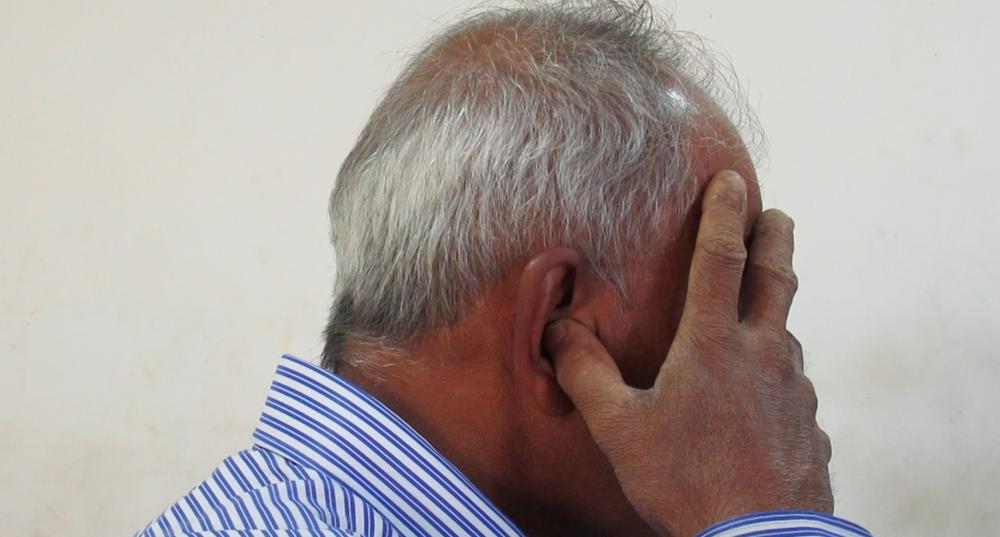 Photo 1. Male patient practicing bhrāmarī prāṇāyāma with a gesture of closing of external sensory perception yōnimudrā. (screenshot of a film recording) | Photo: K. Bierski