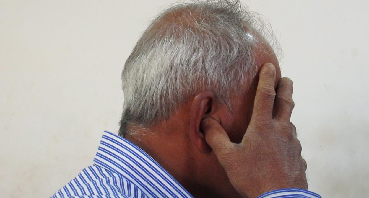 Photo 1. Male patient practicing bhrāmarī prāṇāyāma with a gesture of closing of external sensory perception yōnimudrā. (screenshot of a film recording) | Photo: K. Bierski